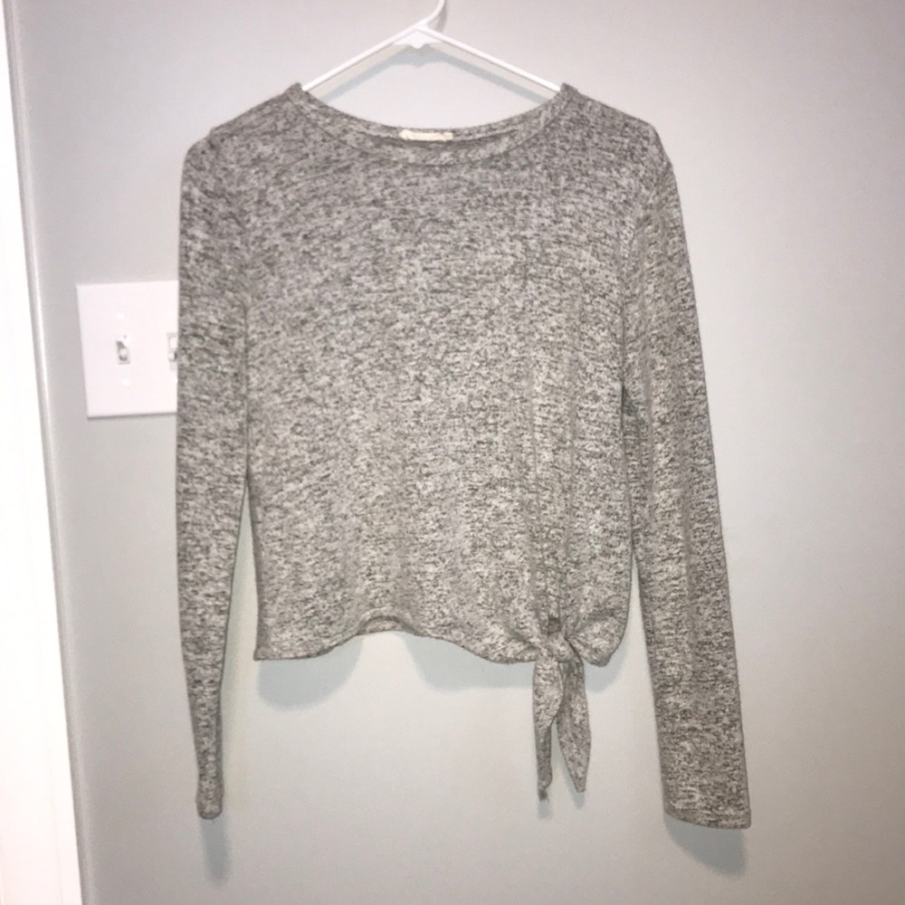 this is a short waisted long sleeved shirt.